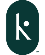 The smaller logo for Kris Fiore Design that is green with a stylized K placed in the center of an oval shaped outline.